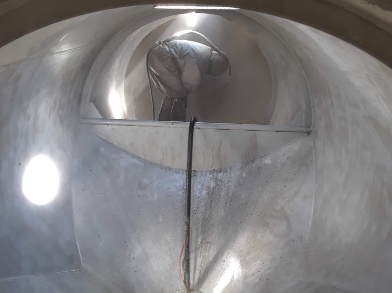 Cleaning cement tanker interior. Georgia