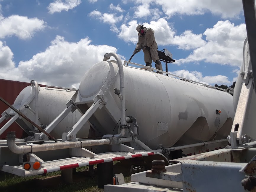 Cleaning cement tanker exterior. Georgia